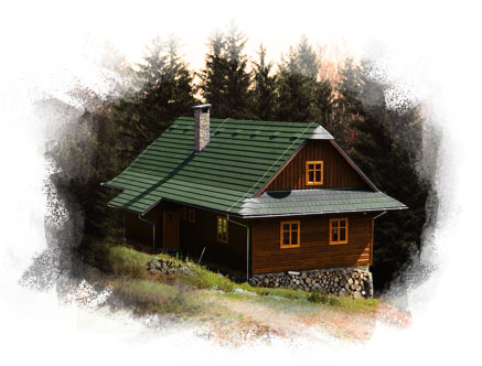 Small, cozy log cottage with a peaked pine-green roof. The front includes a deck area and the cottage features many classic 4-pane glass windows.